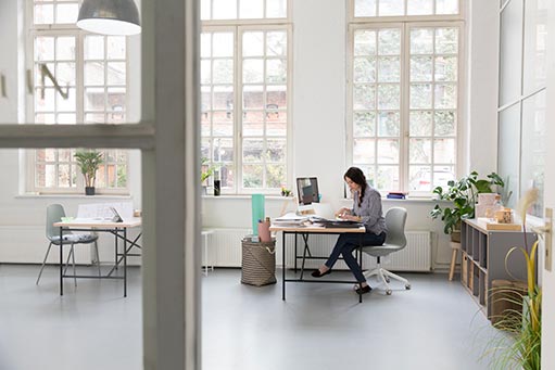 Neal's Accounting & Tax Service Woman working at desk in a loft office