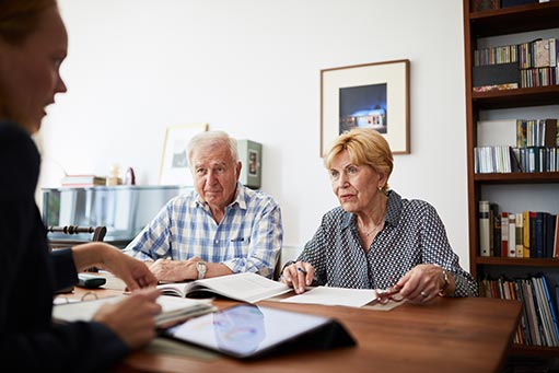 Neal's Accounting & Tax Service Senior couple meeting with financial consultant at home